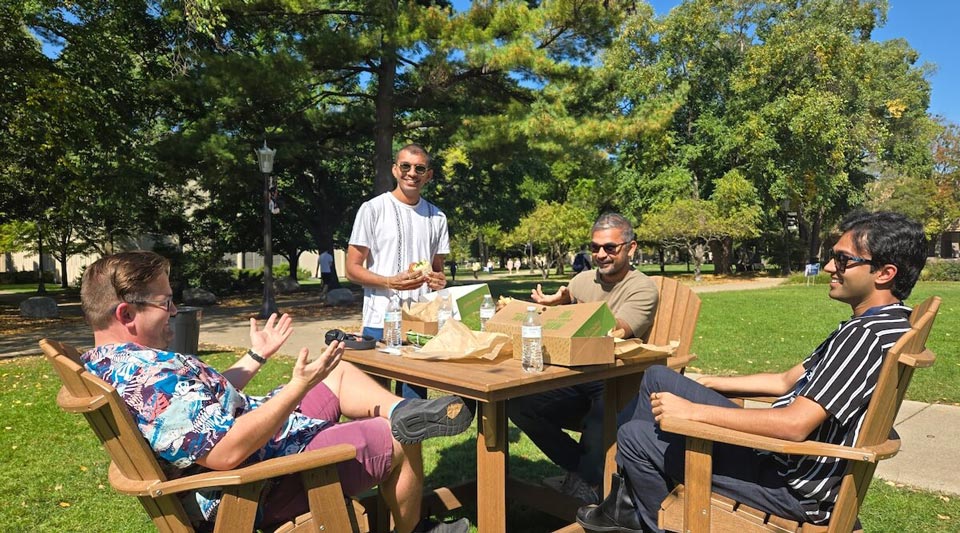 Postdocs enjoying a free lunch on sunny Library Lawn during Postdoc Appreciation Week in 2025.