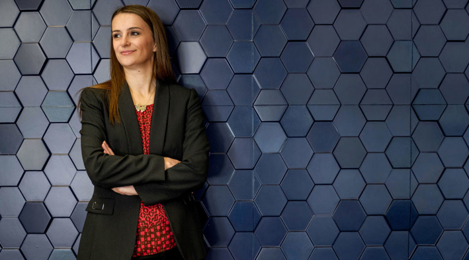 Tijana Milenkovic standing against wall of hexagons